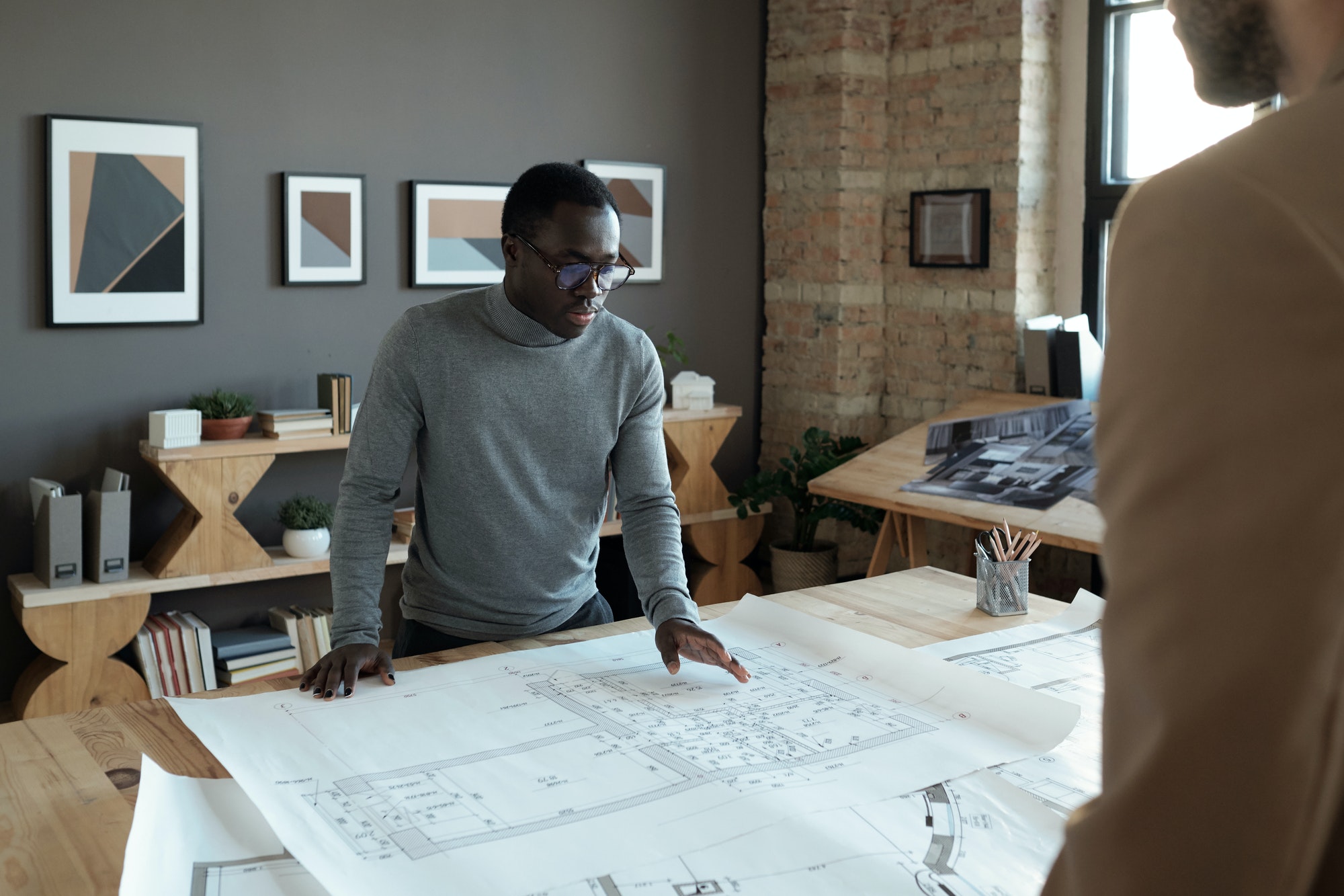 young-confident-african-engineer-looking-at-sketch-during-discussion.jpg