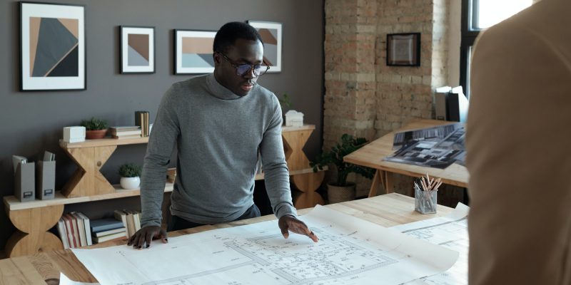 young-confident-african-engineer-looking-at-sketch-during-discussion.jpg